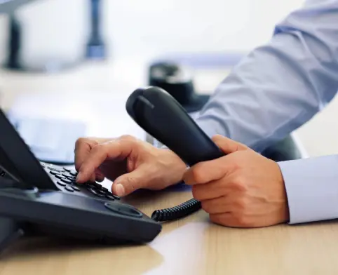 A person is using a phone and keyboard