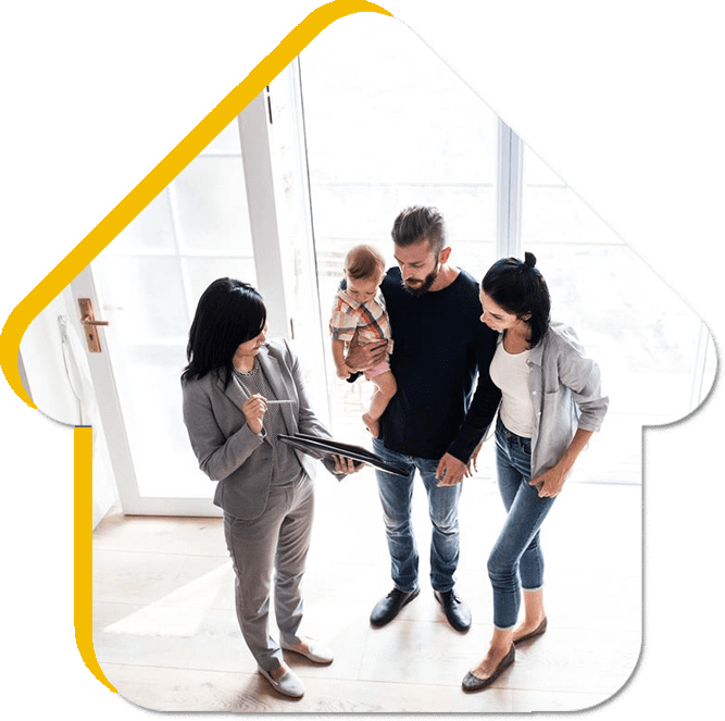 A group of people standing around in front of a house.