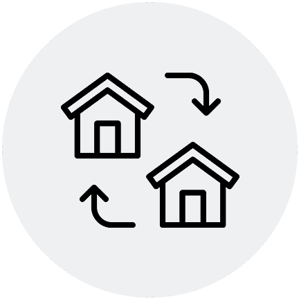 A black and white icon of two houses with arrows.